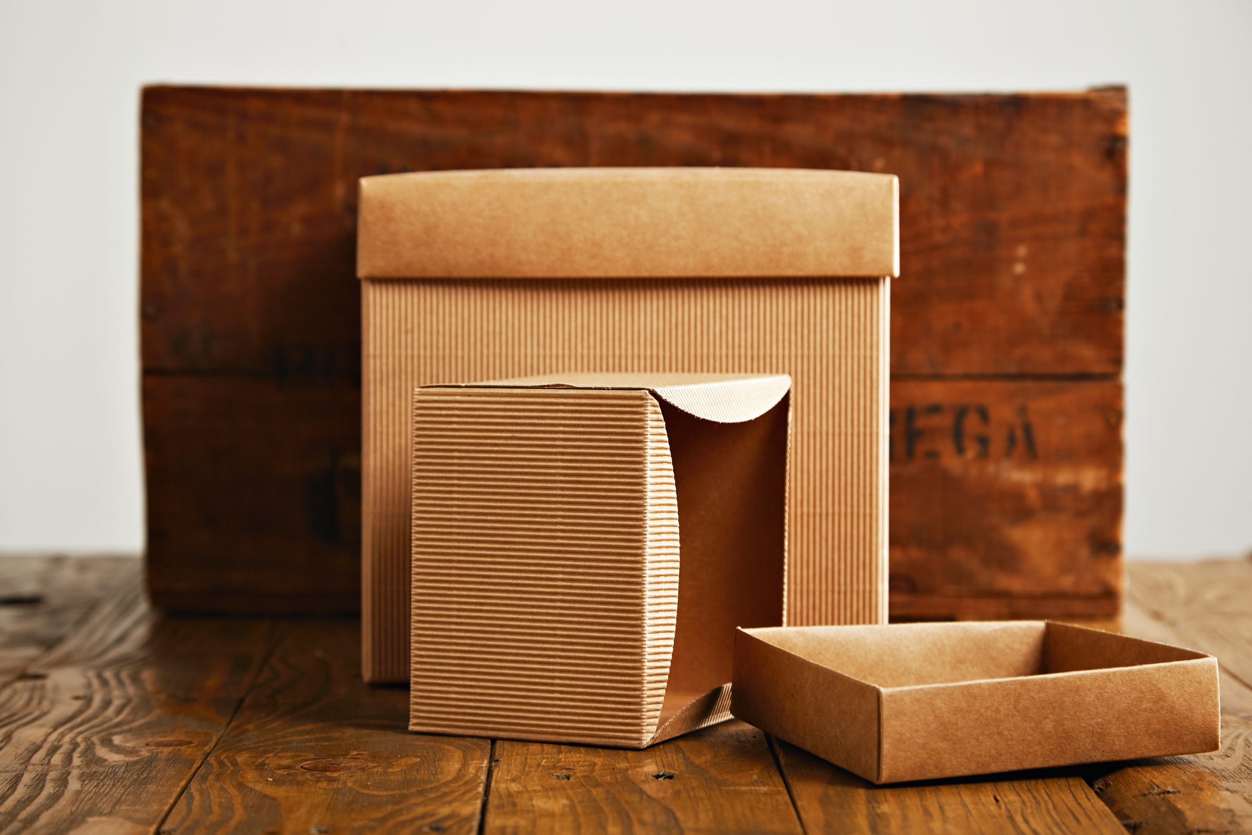 Blank corrugated cardboard boxes with vintage wooden box